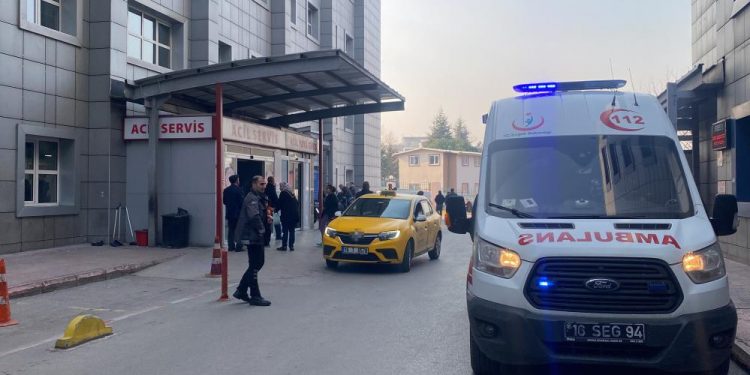 Hastane önünde duran insanlar ve bir ambulans